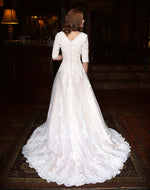 Mon Cheri TR11835 Modest Wedding Dress Back from A Closet Full of Dresses