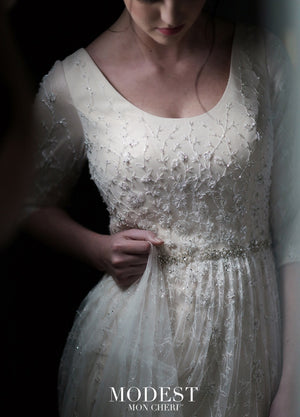 Mon Cheri TR21852 Modest Wedding Dress Close from A Closet Full of Dresses