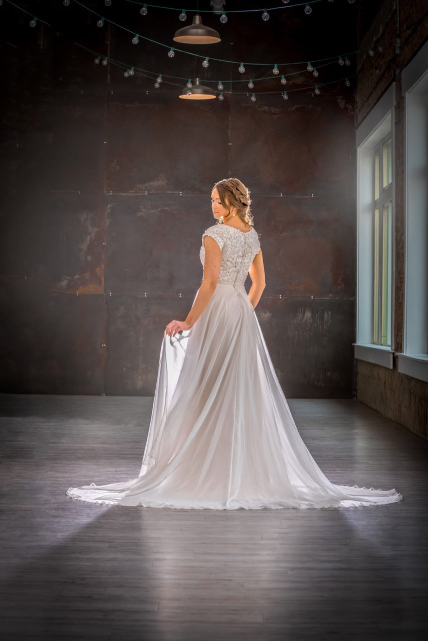 Mon Cheri TR21905 Modest Wedding Dress Back from A Closet Full of Dresses
