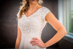 Mon Cheri TR21905 Modest Wedding Dress Close from A Closet Full of Dresses