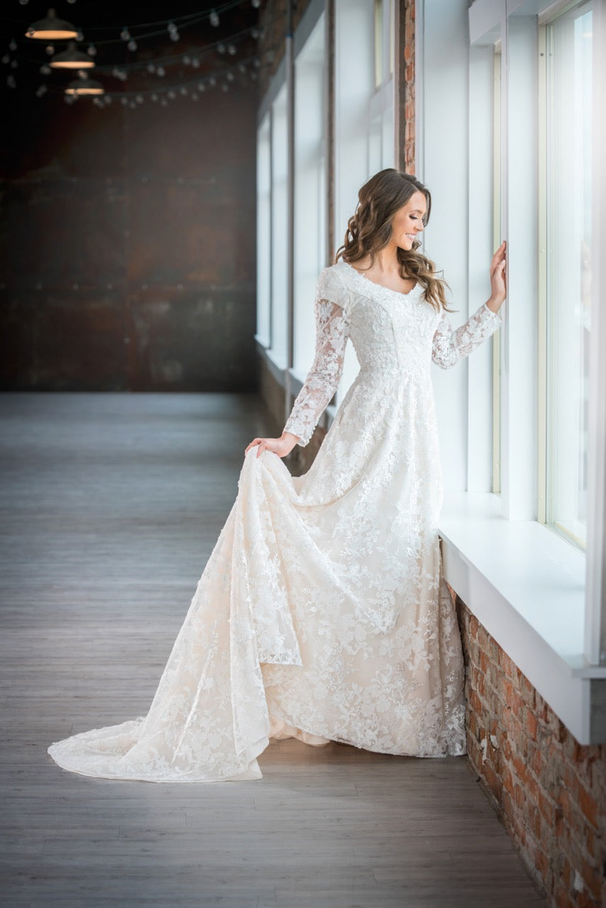 Mon Cheri TR21909 Modest Wedding Dress Side from A Closet Full of Dresses